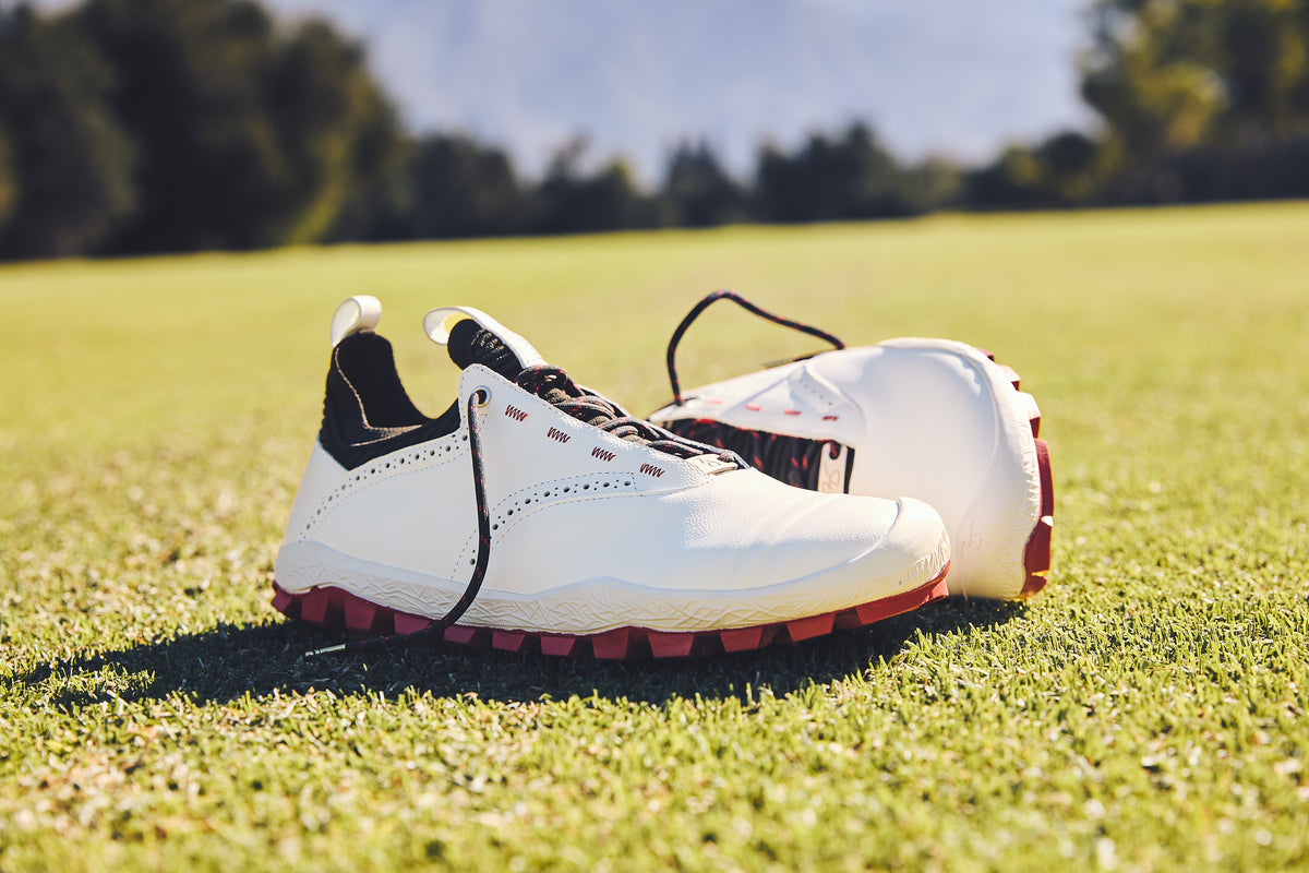 WIN36 shoes resting on a golf bag